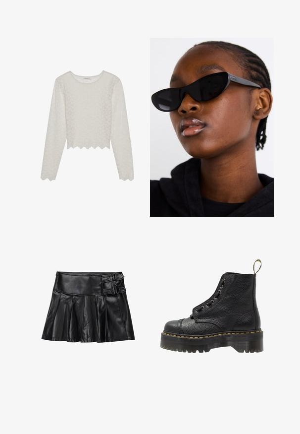 Kremasti dugi rukav majica s reljefnim cvjetnim uzorkom, skraćenog dizajna i rubom sa valovitim završetkom. Izrađena od lagane, poluprozirne tkanine.; Crna kožna suknja s plisovima, širokim pojasom i dva akcenta s kopčama sa strane. Glatka tekstura s sjajnim završetkom.; Crne kožne gležnjače s teksturiranom površinom, okruglim vrhom, vezanjem, žutim šavovima i debelim, rebrastim crnim platformama.; Crne mačje naočale s mat finišem, koje imaju elegantan dizajn i blago zakrivljene rubove, postavljene na pozadini tamne odjeće modela.