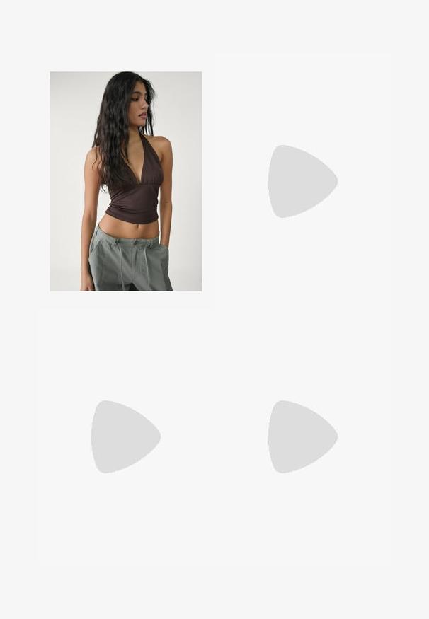 Brown halter top with a deep V-neck and gathered fabric at the bust, paired with loose, light gray cargo pants featuring adjustable waist ties.; Light blue flared jeans made from denim. Features a front button closure, five pockets, and subtle fading for texture.; Brown leather cowboy boot with a pointed toe, wedge heel, and decorative embroidery. Features a tall shaft and pull tab.; Cat-eye sunglasses with a black and orange tortoiseshell frame, brown lenses, and sleek, pointed tips. Features a minimal logo on the temple.; Gray cropped shirt, dark pants, and metallic silver flats. Holding a dark brown textured bag with a silver buckle. Simple design and soft materials.
