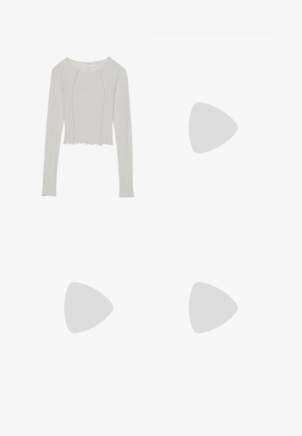 Light gray long-sleeve top with a ribbed texture, cropped design, round neckline, and scalloped hem. Features seam detailing down the front.; Black knitted skirt with a textured pattern, mid-length, and wide waistband. Material appears soft with a slightly fuzzy surface.; Black leather platform loafers with a rounded toe and wide strap across the vamp. Features a chunky, square heel and smooth texture.; Woman with long dark hair wearing a black suit, carrying a black leather shoulder bag, looking over her shoulder against a white background.; Silver hoop earrings with a twisted design, featuring a polished finish and post-back closure. Measure approximately 3 cm in diameter.