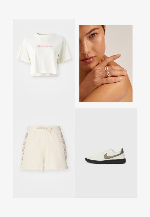 Camiseta cortada de color crema hecha de algodón. Presenta un logo bordado en rosa que dice "Nike Sportwear". Mangas cortas y un escote redondo.; Shorts de color crema con canalé y cintura con cordón, que presentan patrones decorativos en marrón de flores y geométricos en los lados.; Nike Sportswear FIELD GENERAL - Zapatillas - off-white/black; Anillo plateado retorcido con un diseño texturizado, llevado en una mano que descansa sobre un hombro. El tono de piel es cálido y las uñas son cortas.