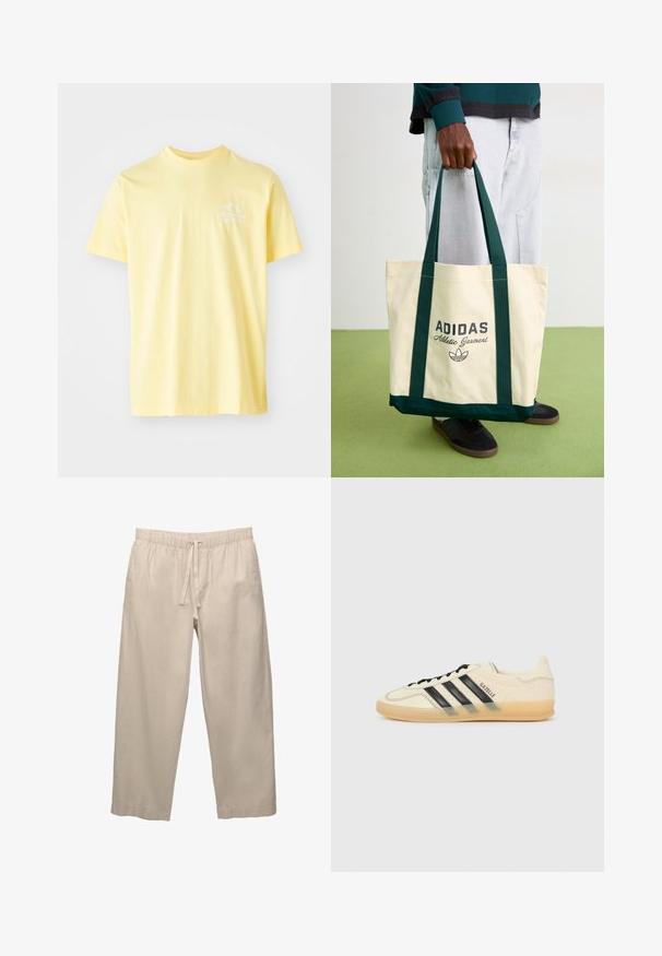 Žuta pamučna majica s okruglim izrezom i kratkim rukavima. Sadrži mali bijeli grafički dizajn na lijevoj strani grudnog koša.; Bež, lagane, pamučne hlače s elastičnom trakom u struku i vezicom. Dizajn širokih nogavica i mogući rukavi. Glatka tekstura, minimalno ukrašen.; Svijetlosmeđi tenisice s crnim dizajnom tri pruga, teksturirana gornja strana, okrugli vrh i đon od gume. Ima vezice i brendiranje sa strane.; Osoba drži bež Adidas torbu sa tamnozelenim drškama, nosi svetlosive pantalone i crne patike na zelenom podu.