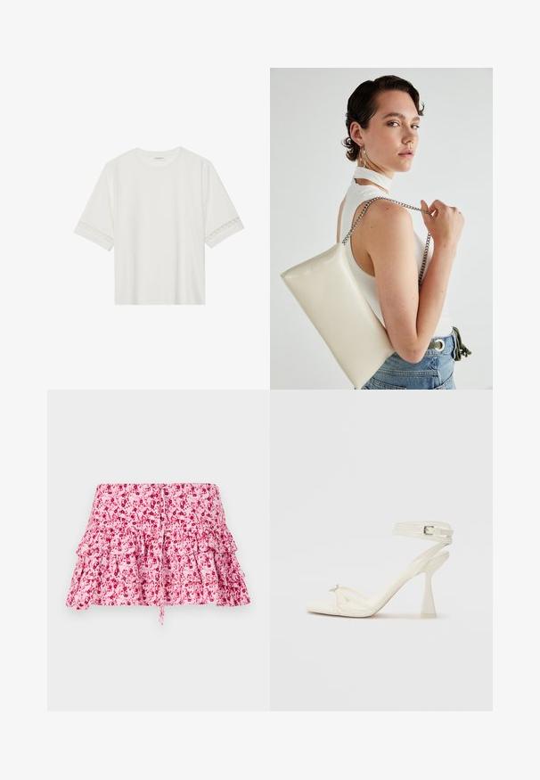Fehér, rövid ujjas póló, pamutból készült, díszes csipkés szegéllyel az ujjak mentén és kerek nyakkivágással.; Rózsaszín virágmintás szoknya fodros rétegekkel, húzózsinórral ellátott derékkal. Az anyag puha tapintású, sötétebb árnyalatú virágmintákkal.; Fehér bőr, pántos, magas sarkú szandál, letisztult limezéssel, átlátszó blokk sarkakkal és díszítő elemmel a lábujjaknál.; Fehér, téglalap alakú, fényes anyagból készült clutch táska, ezüst láncos pánttal. A modell pózol, bemutatva a táskát egy egyszínű háttér előtt.