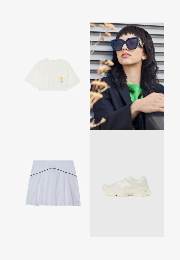 Tricou alb scurt din bumbac, cu mâneci scurte, având un grafic cu palmier galben și val albastru pe partea stângă a pieptului.; Fustă sport albă cu hem flared, având o linie de accent albastră în jurul taliei și un logo în colțul din dreapta jos.; Adidaș ușor, cu un superior din plasă și piele întoarsă în nuanțe de crem moale, cu o talpă groasă și accente tridimensionale.; Ochelari de soare supra-dimensionați, de culoare neagră, cu un cadru gros și accente aurii, purtați cu un sacou negru și o cămașă verde aprins, pe un fundal orizontal.