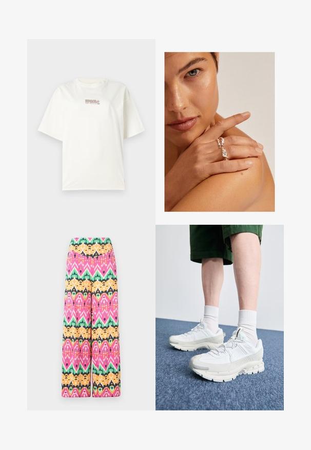 White crew neck t-shirt with short sleeves, featuring a small red and brown logo text at the center front. Made of cotton material.; Multicolored wide-leg trousers featuring a geometric pattern in pink, green, orange, and black. Made of lightweight fabric with a smooth finish.; White athletic shoes with textured overlays, a chunky sole, and gray accents. Worn with white crew socks and green shorts on a blue surface.; Silver twisted ring with a textured design, worn on a hand resting on a shoulder. Skin tone is warm with short nails.