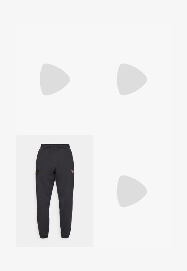 White soccer jersey with black accents, gradient orange-yellow shoulder design, three stars, and a textured geometric pattern.; Black sweatpants with elastic waistband, tapered fit, featuring an embroidered emblem and a gold Adidas leaf logo on the side.; Black sneakers with glossy patent leather accents, textured fabric, flat laces, and a rubber sole, paired with black socks, on a yellow surface.; Silver-toned metal necklace featuring a twisted chain design and a circular pendant with a polished finish.