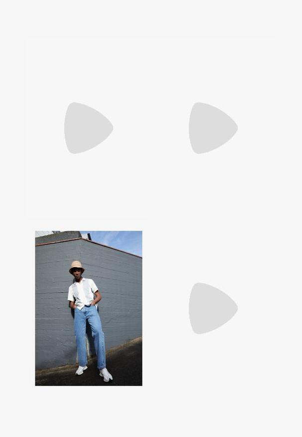 BOSS PASSERTIP - Polo shirt - open green; Short-sleeve white shirt with light gray stripes, blue denim jeans, and white sneakers, set against a gray wall under clear blue sky.; White leather sneakers with perforations, round toe, flat sole, and thick laces, featuring a visible swoosh logo and "AIR" on the heel.; Silver stainless steel wristwatch with a navy blue dial, metallic hour markers, and a date window at 3 o'clock. Water-resistant to 50 meters.