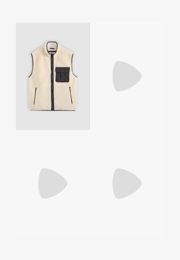 Cream fleece vest with a black zip closure, side pockets, and a front patch pocket featuring a button detail. Contrast edging is visible.; Brown and cream striped long-sleeve top with a rounded neckline, ribbed texture, and dropped shoulder seams, featuring a cropped cut.; Light blue denim jeans with a loose fit, mid-rise waist, and straight legs. Features five pockets, belt loops, and a button closure.; Leather sneakers with a black and cream color scheme, featuring perforated accents, a padded collar, and a textured outsole.