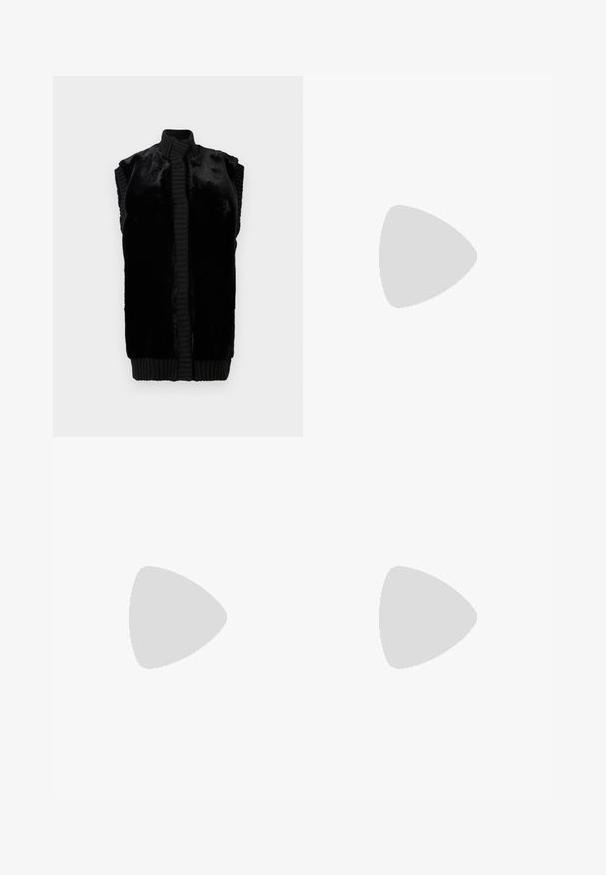 Black sleeveless vest made of soft faux fur with a ribbed collar and hem, featuring a straight silhouette and no visible fastenings.; White short-sleeve t-shirt made of lightweight cotton. Features a round neckline and rolled sleeves. Red logo tag on the collar.; Light blue flared jeans made from denim, featuring a high waist, pockets, and frayed hems. The fabric displays a faded wash and subtle texture.; Black leather loafers with a smooth finish, stitched detailing around the toe, and a low rubber sole. Paired with wide black trousers.